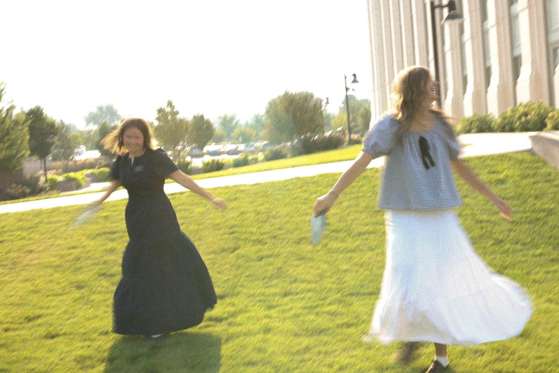 Portrait twirling in a dress on the lawn